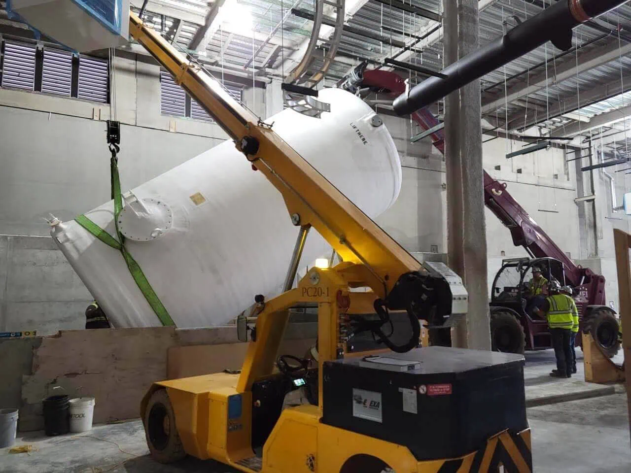 Heavy rigging and machinery moving of a fiberglass waste tank by MEI Industrial Solutions.