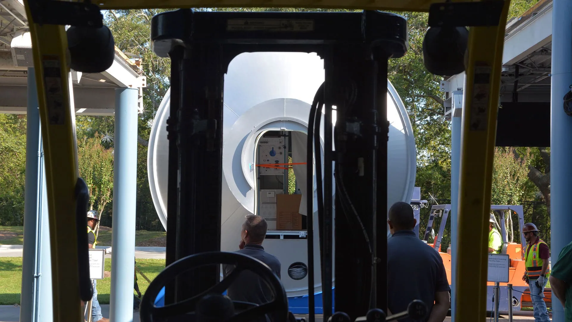 Heavy machinery moving with industrial rigging for space habitat installation.