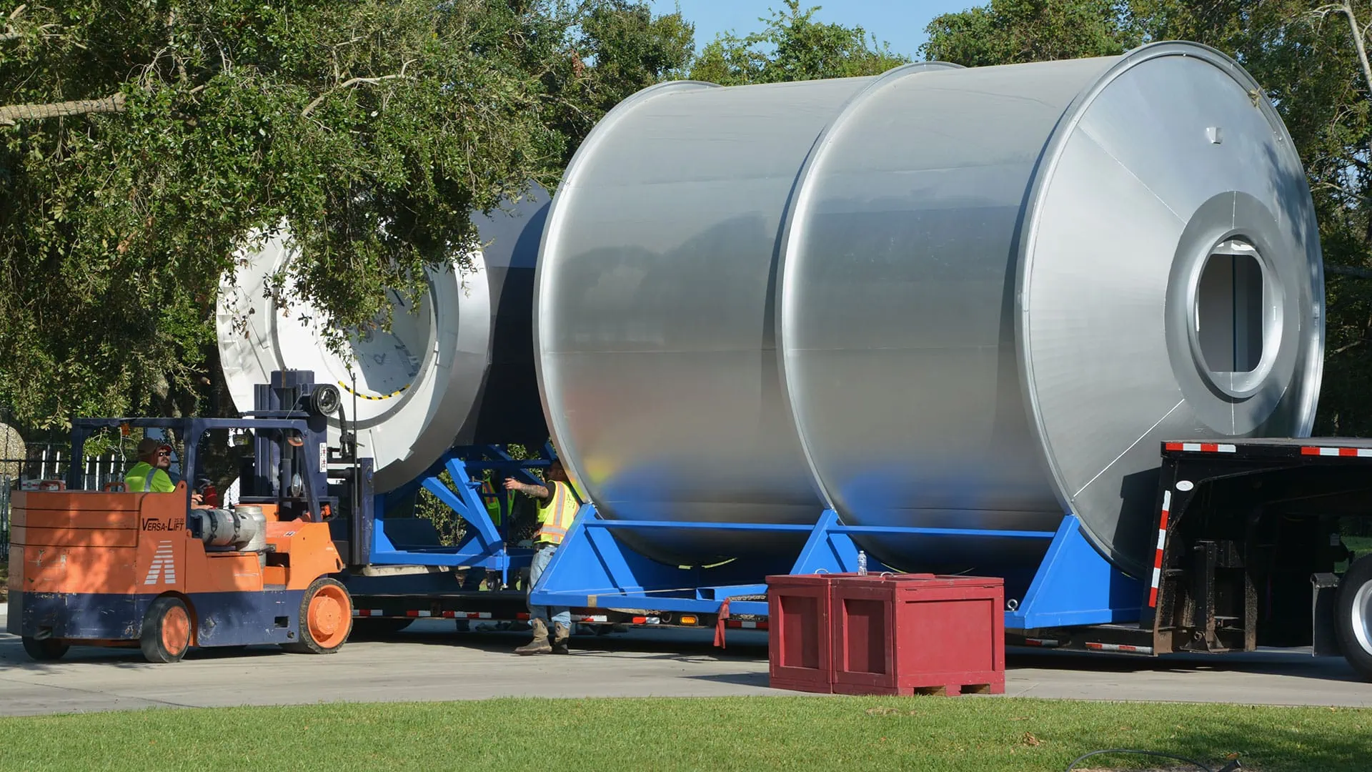 Heavy industrial tank being transported by MEI Industrial Solutions with machinery moving expertise.