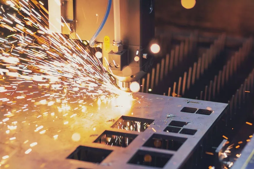 Precision metal cutting with sparks in industrial manufacturing.